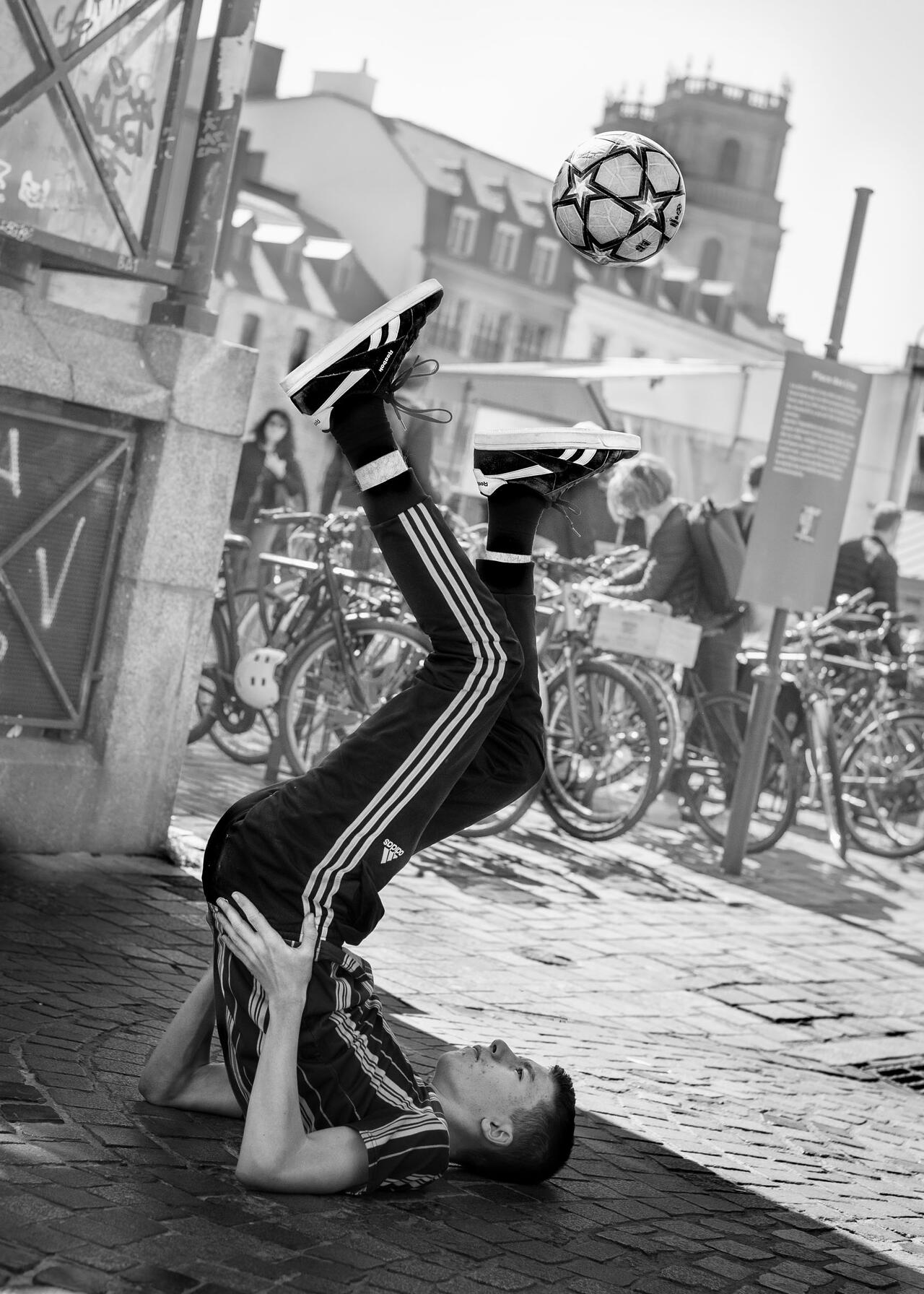 Un homme jongle avec un ballon.